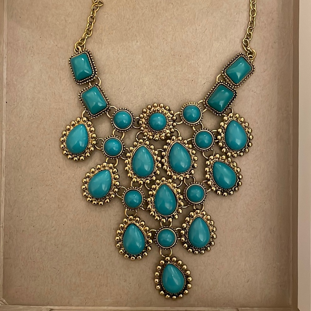 Costume jewelry, statement necklace in gold with turquoise stones